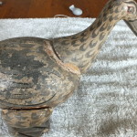 A damaged coconut shell duck awaiting repair